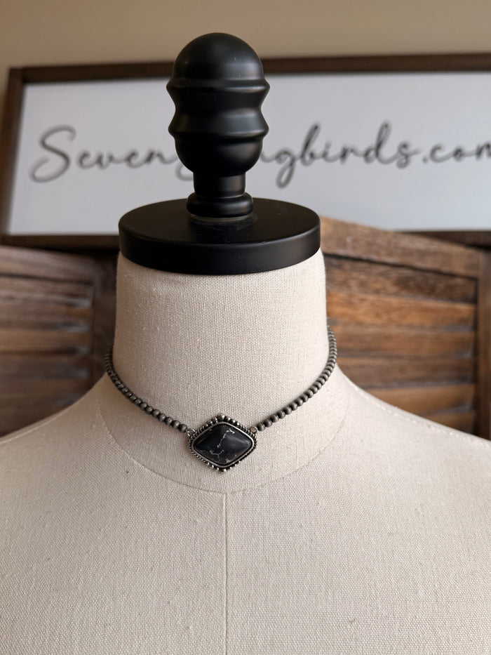 Stone pendant necklace with silver chain and centered dark square pendant charm