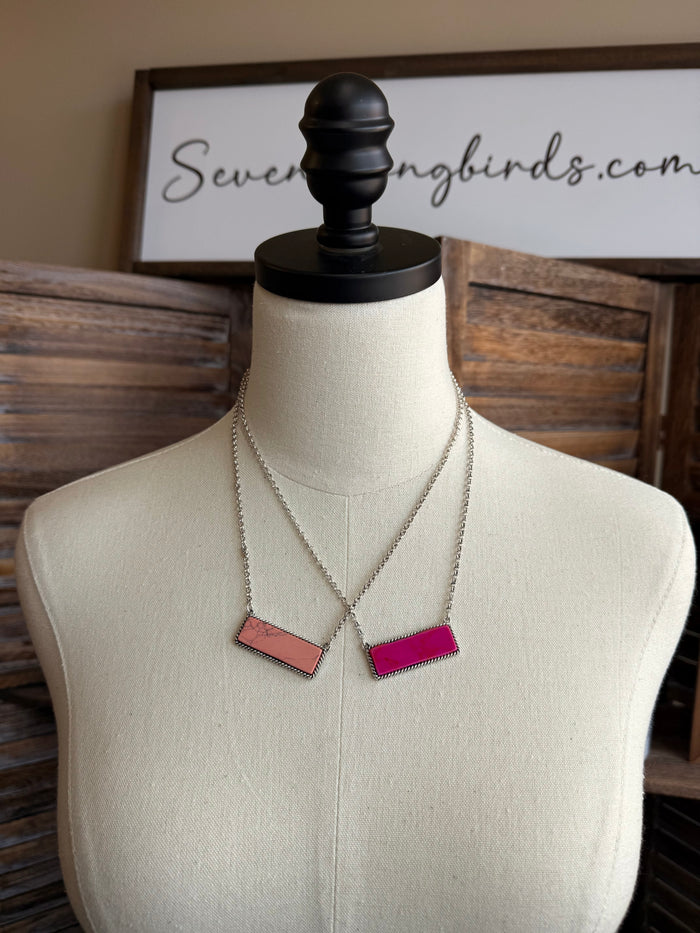 Stone bar necklace with peach and pink rectangular pendants on silver chain