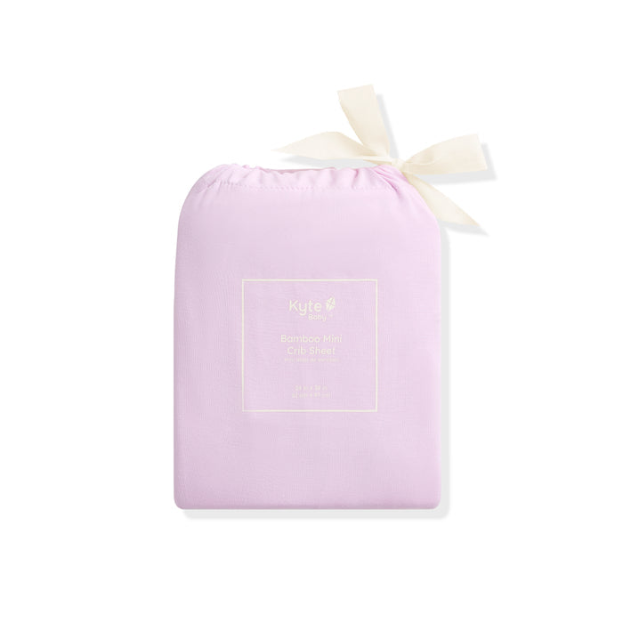 Purple drawstring bag with a white ribbon on a white background