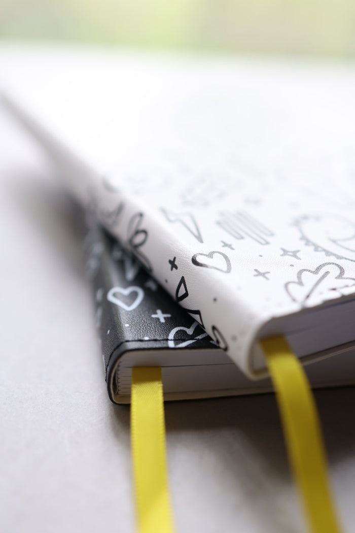 Artistic close up of journals stacked showing yellow bookmarks