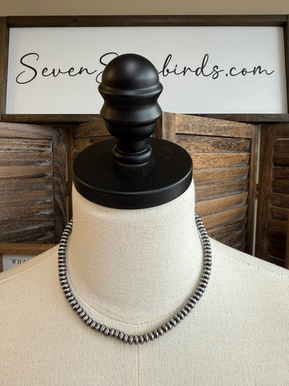 Silver-tone saucer beaded necklace on mannequin bust, 16-inch length.