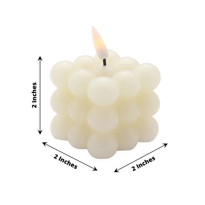 White bubble candle with a lit wick, measuring 2 inches in all dimensions.