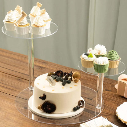 Elegant cake and cupcakes on transparent stands, perfect for celebrations.