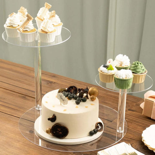 Elegant cake and cupcakes on transparent stands, perfect for celebrations.