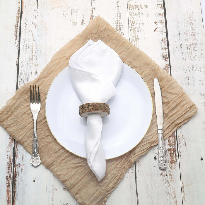 Elegant table setting with white plate, folded napkin, and decorative napkin ring.