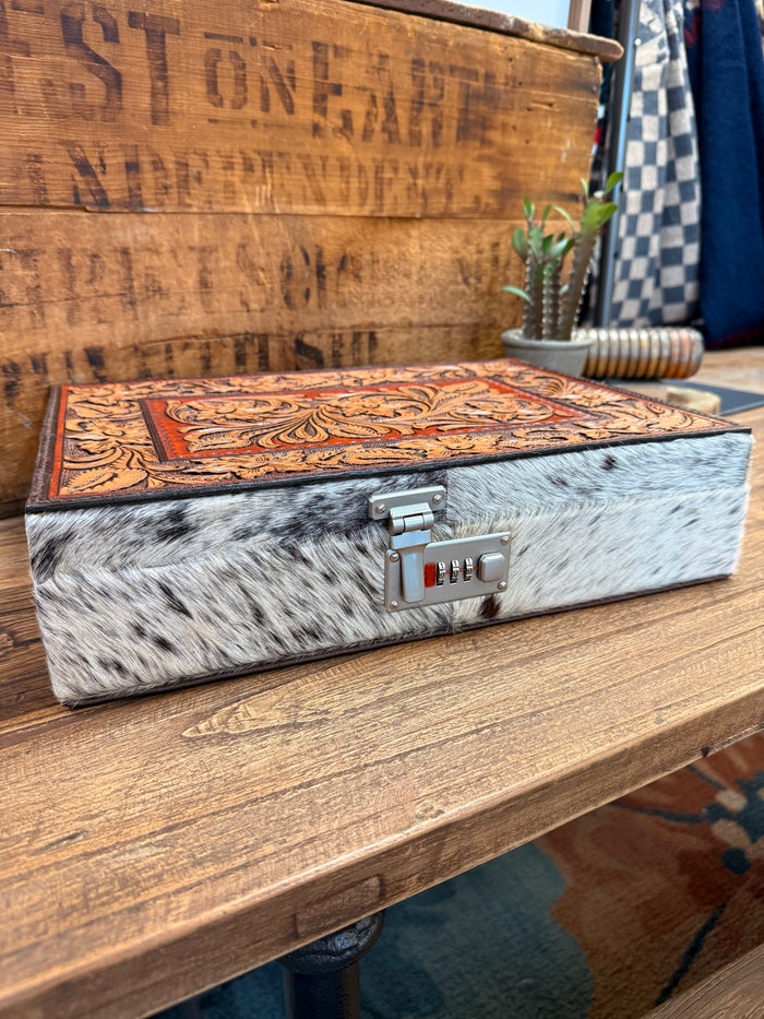 Rectangle hair-on jewelry box with orange floral tooled lid and metal combination lock