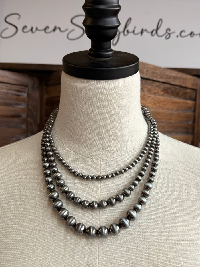 Triple-layer pearl necklace, three rows of silver-toned beads