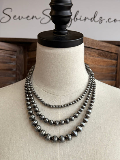 Triple-layer pearl necklace, three rows of silver-toned beads