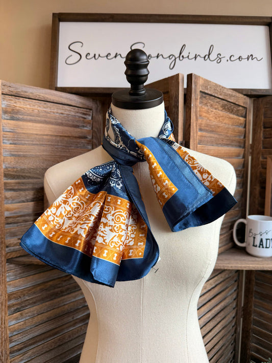 Navy gold cream paisley wild rag scarf, draped on mannequin with long tails