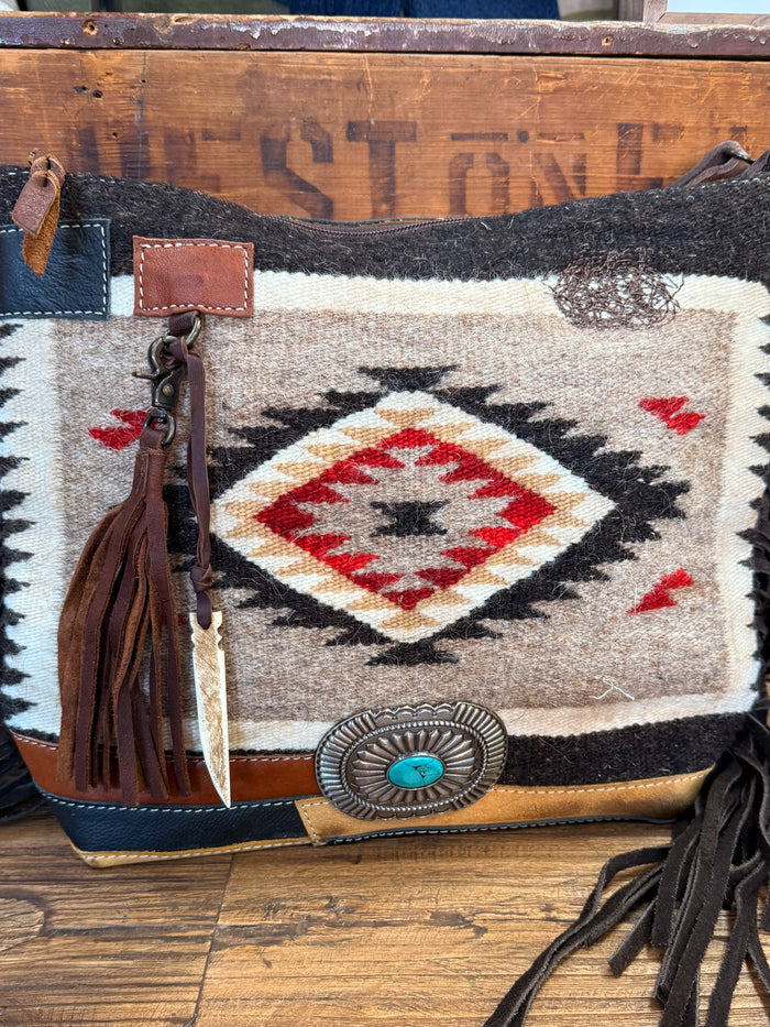 Woven wool crossbody purse with geometric diamond motif, leather corners, and fringe tassels