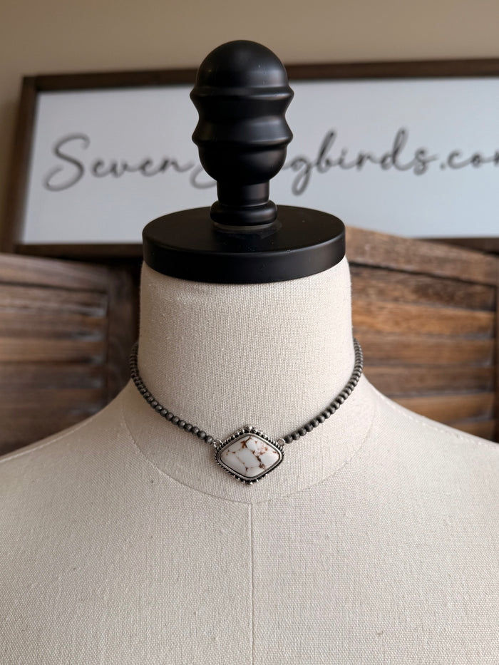 Stone pendant necklace with silver chain and centered oval white pendant charm