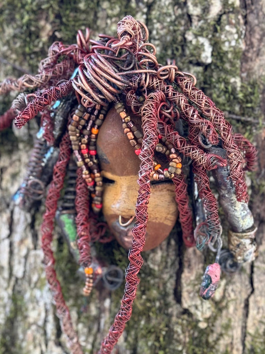 Ayanna is a wise, distinguished youth with a two-tone tribal look. He stands 7" x 10" and weighs 1 lb.  His braided hairstyle features handmade textured metallic beads plus a twist of coiled 16 gauge wire.  Questions? Send an instant message or chat with me.