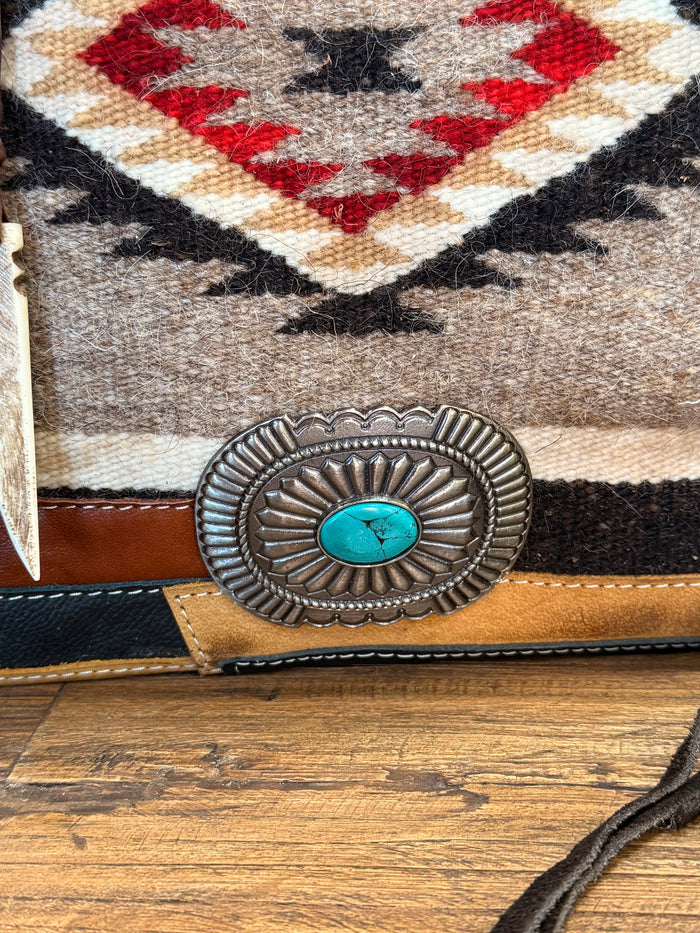Woven wool crossbody purse with large turquoise concho on leather strap trim