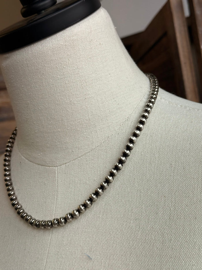 18-inch pearl necklace close-up: dark 5mm round beads with metallic sheen