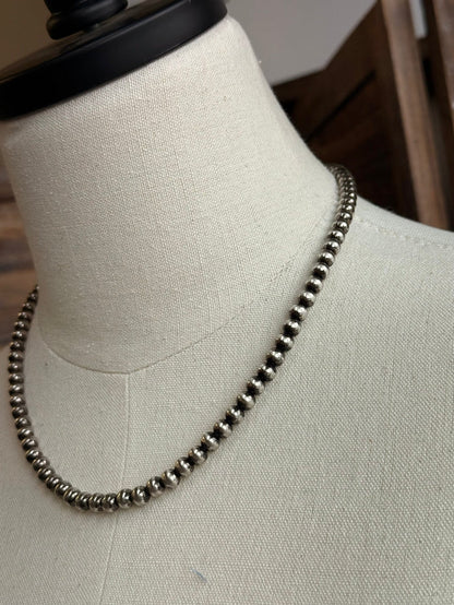 18-inch pearl necklace close-up: dark 5mm round beads with metallic sheen