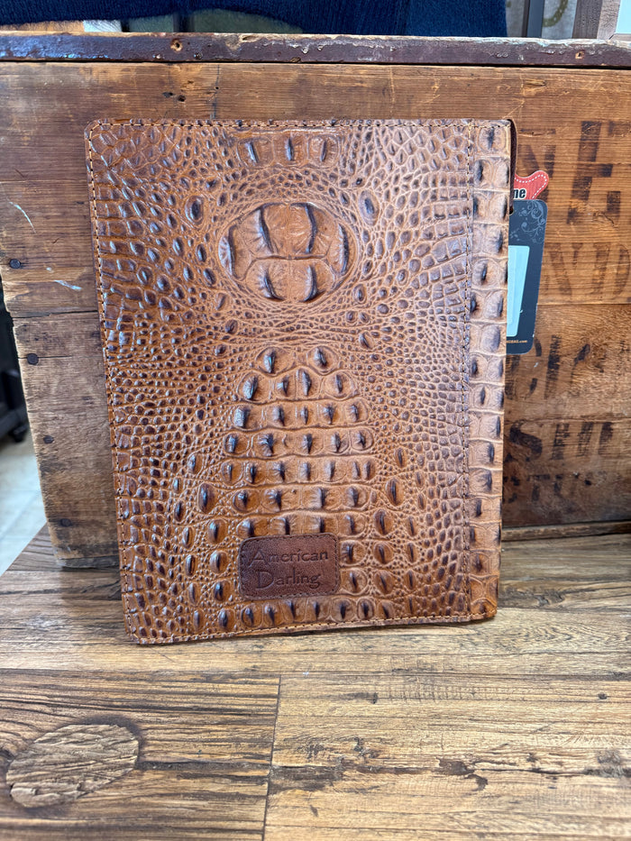Crocodile-embossed notebook portfolio folder with round crest and stamp logo