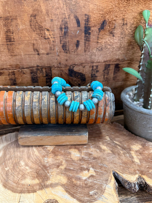 Turquoise beaded bracelet with silver-tone spacer beads and wire clasp