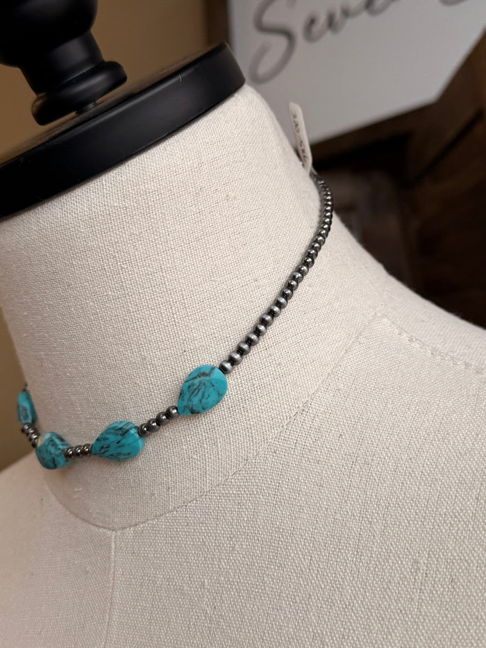 Turquoise oval stone bead choker necklace detail with dark chain