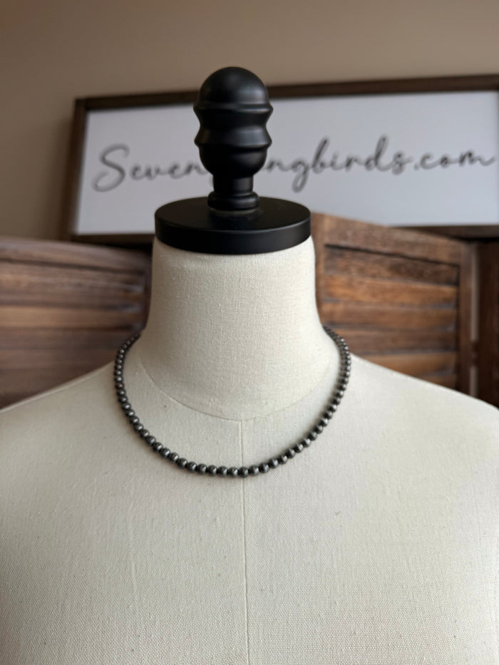 Silver-toned beaded necklace with double rows on mannequin bust