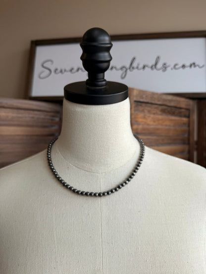 Silver-toned beaded necklace with double rows on mannequin bust