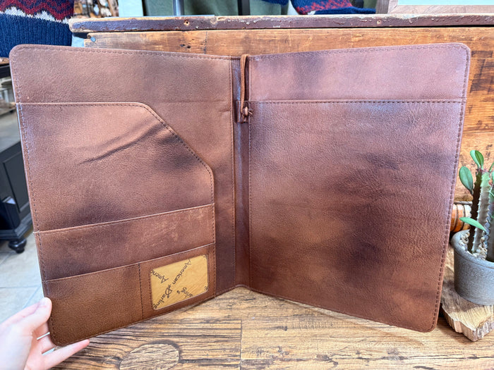 Notebook folder interior with two brown leather-look panels and inner pocket
