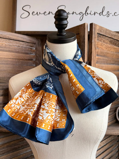 Navy gold cream paisley wild rag scarf, folded with blue and orange patterned ends