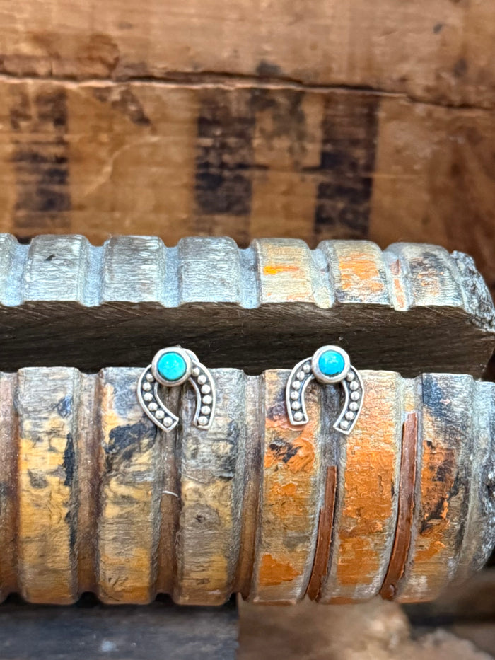 Pair of sterling horseshoe stud earrings with turquoise stone centers and scalloped accents