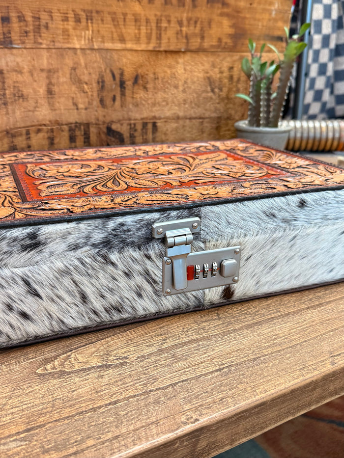Rectangle hair-on jewelry box with floral tooled top, silver lock, and number keys