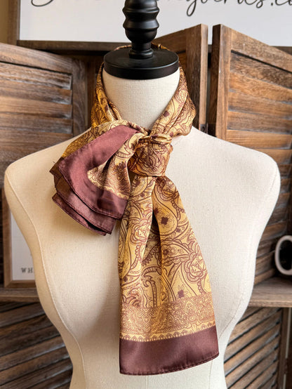 Gold paisley wild rag scarf with burgundy edge, tied bow at neckline