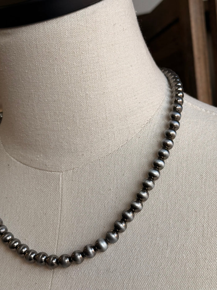 Close-up 17-inch silver pearl bead necklace with round bead details