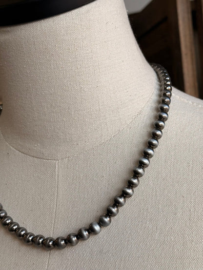 Close-up 17-inch silver pearl bead necklace with round bead details