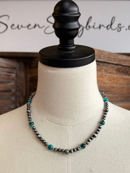 Turquoise stone beaded necklace on bust; silver-tone chain, 18-inch length