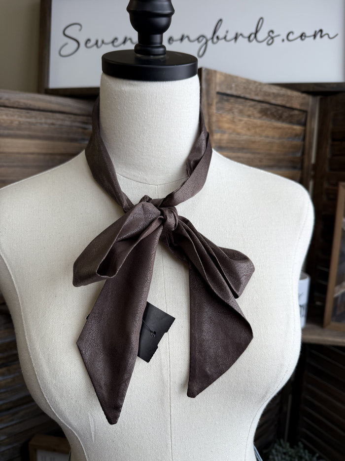 Chocolate brown leather twilly scarf with bow knot at neckline.