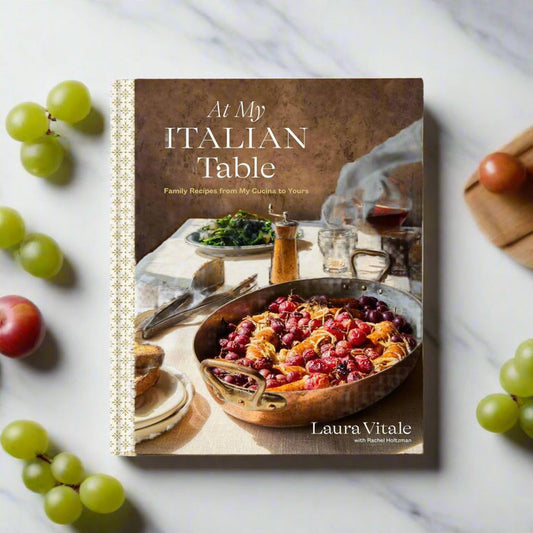 cookbook cover with picture of sausage and grape dish on a set table