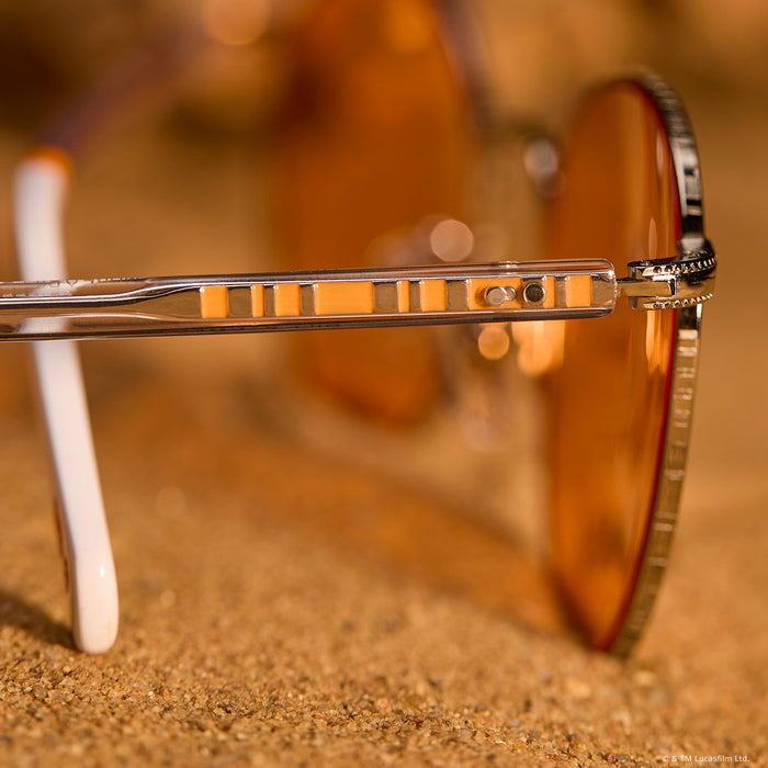still life - laying on sand star wars x diff eyewear featuring the bb-8™ round sunglasses with a droid white with silver frame and orange lenses detailed view