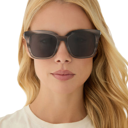 on model - blonde female wearing diff eyewear featuring the bella square sunglasses with a smoke marble frame and grey polarized lenses front view
