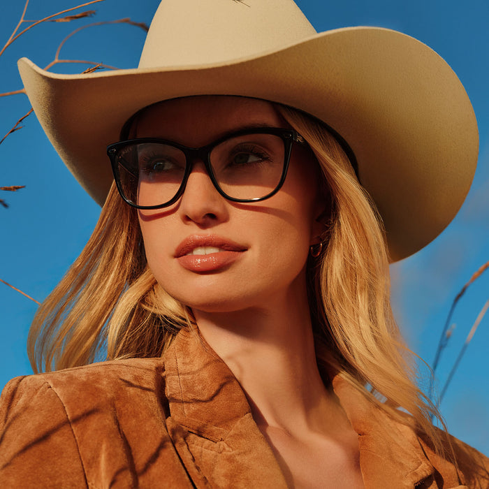lifestyle - female with cowboy hat wearing on model - yellowstone x diff eyewear featuring the beth iii prescription glasses in black front view