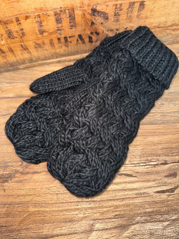 Black cable knit mittens with ribbed cuffs and textured cable pattern