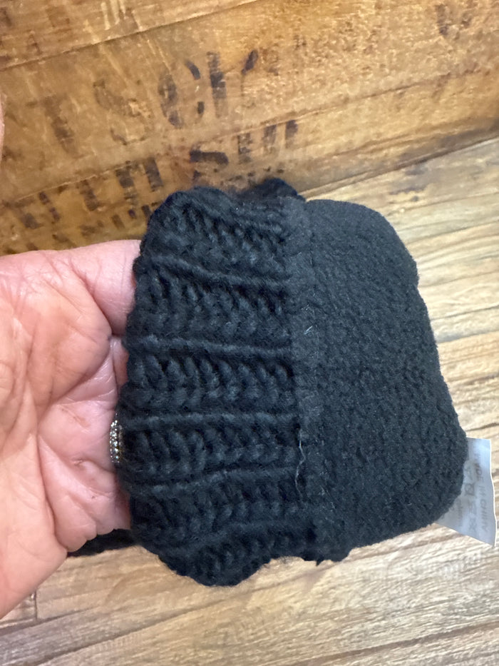 Black cable knit mitten with ribbed cuff and cable-knit texture, close-up