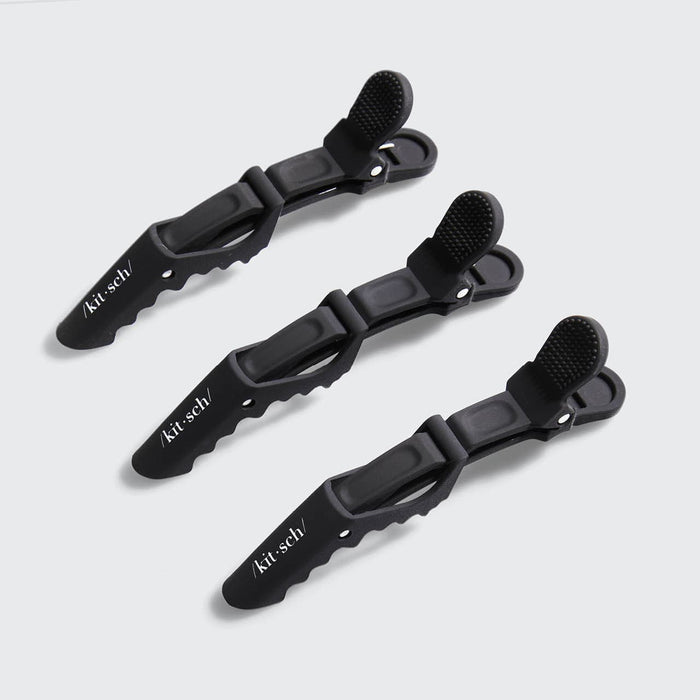 Three black no-slip alligator hair clips arranged on a gray background.