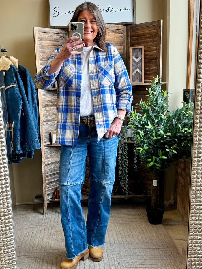 Blue plaid shacket with button-front and long sleeves, small brown buttons