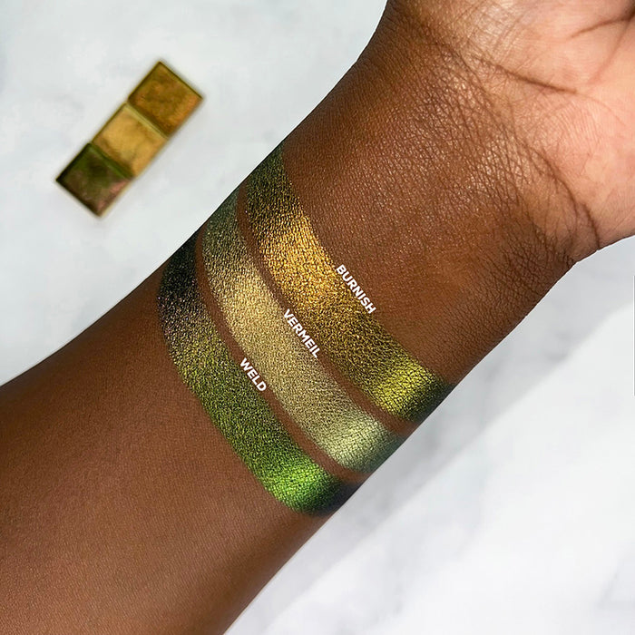 Arm swatch of Jewelled Multichrome Burnish on deep skin.