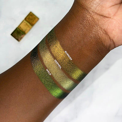 Arm swatch of Jewelled Multichrome Burnish on deep skin.