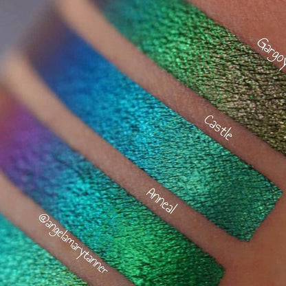 Close up arm swatches on medium skin tone of Castle Jewelled Multichrome Eyeshadow shifts compared to Gargoyle, Anneal