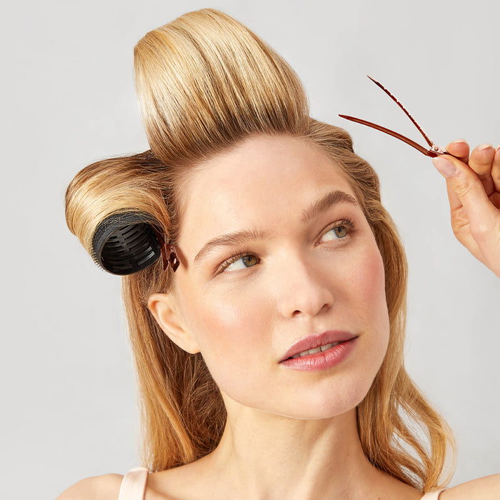 Model using KITSCH Ceramic Thermal Rollers and Rose Gold Styling Clips to set long-lasting waves and volume