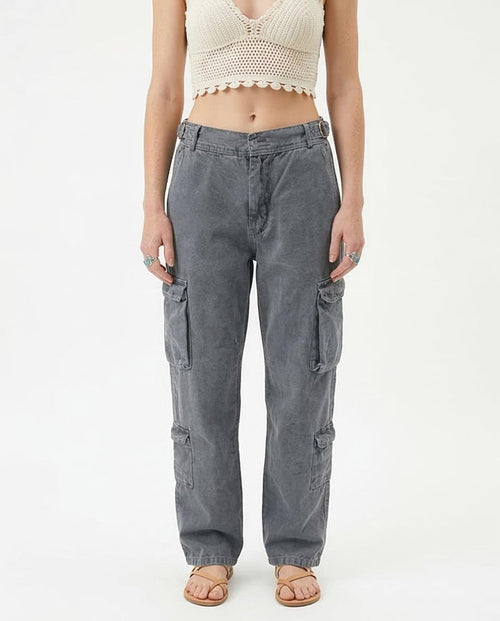 Woman wearing gray cargo pants on a white background