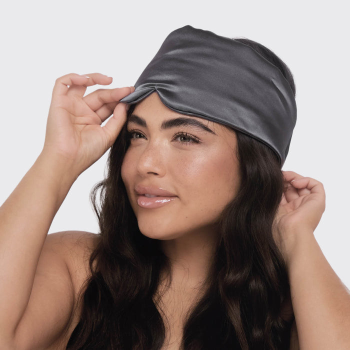 Model wearing Charcoal Satin Pillow Eye Mask in bed showing comfortable fit