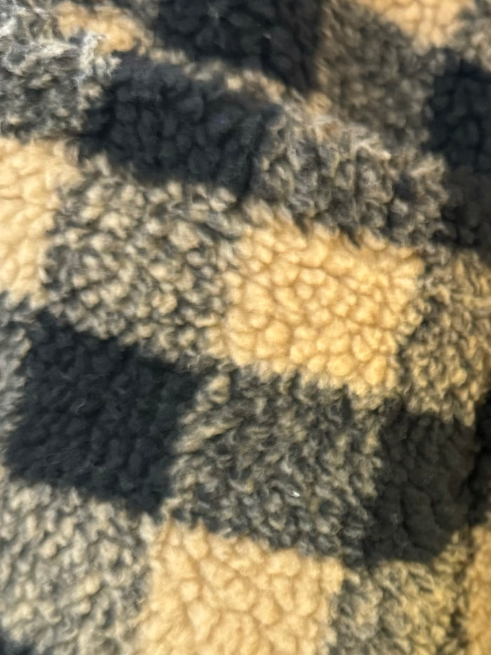 Close-up of sherpa check pattern in black and tan