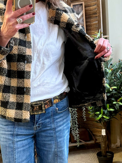Open checkered sherpa jacket showing black lining and front buttons, side pockets