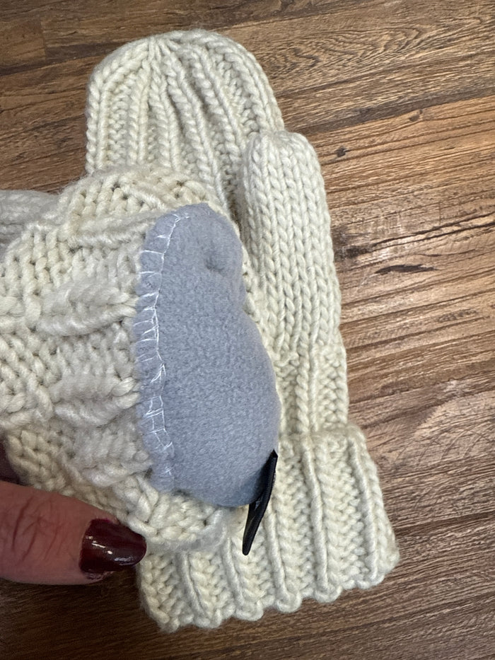 Cream cable knit mitten with gray suede-like palm patch and cuff fold-over